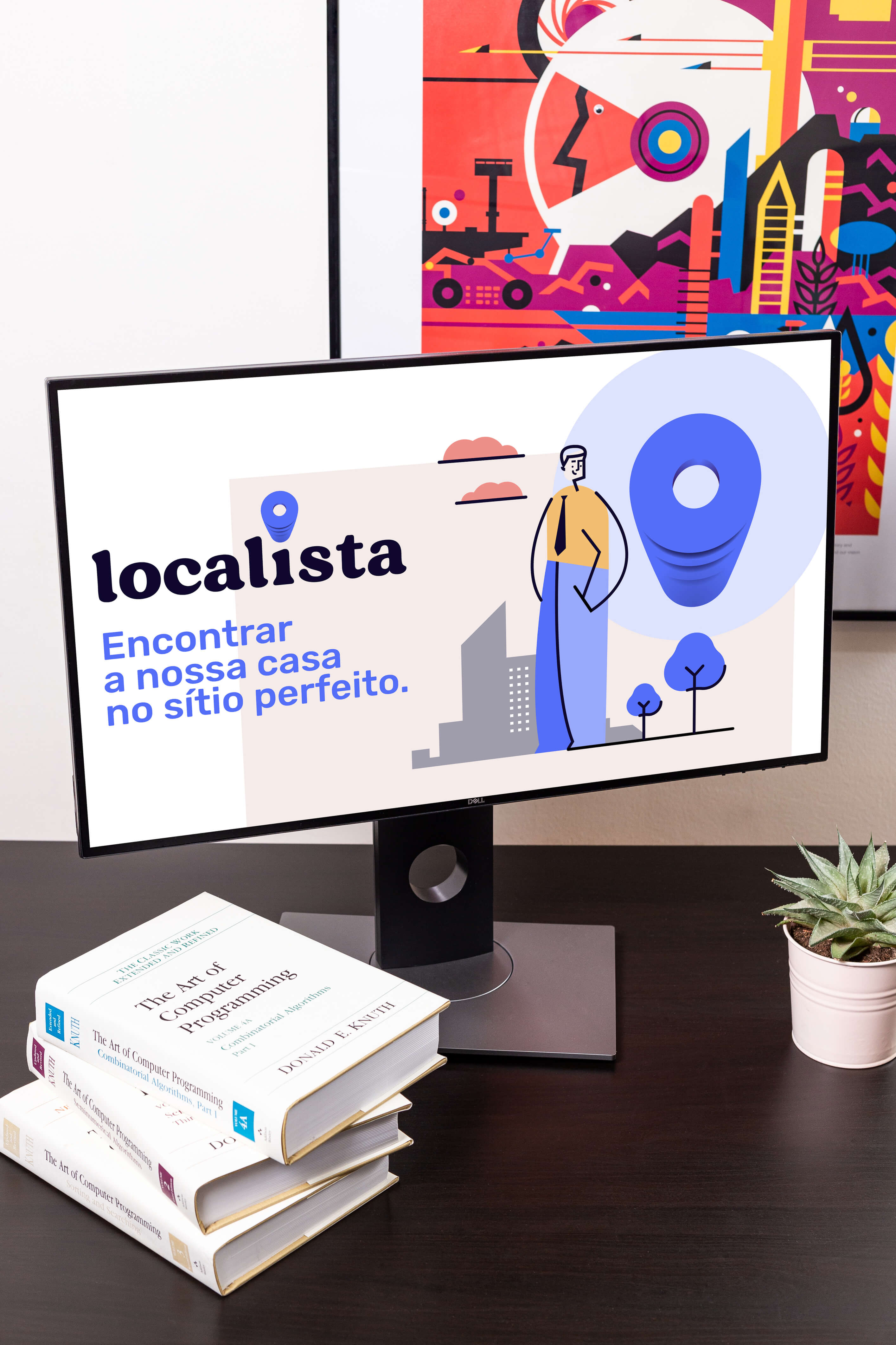 A table with a plant, books and a screen with Localistas logo