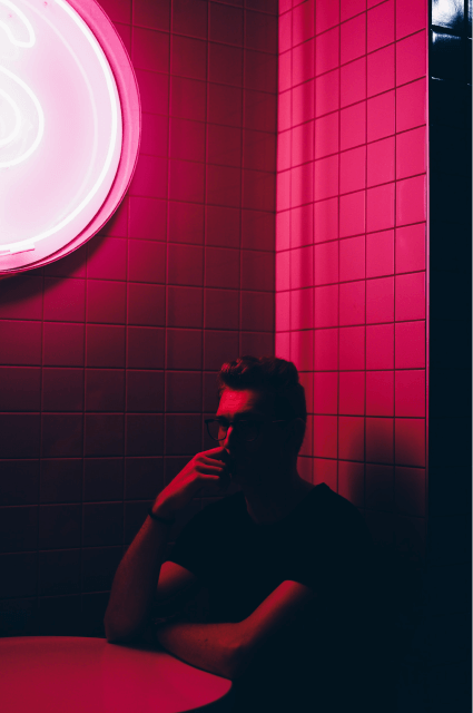 Someone in the shadow in a room with pink light